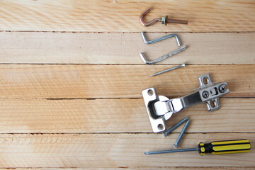 Set of tools and accessories for assembling furniture on the wooden background with a copy space