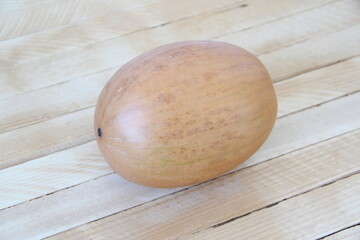 Small round pumpkin on wooden background