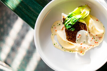 Fried fillet dorado fish with mushed potato and sauce