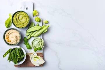 Foto op Aluminium Green spring vegetable appetizer platter with dips. Healthy crudites snack board on white marble background. © sveta_zarzamora