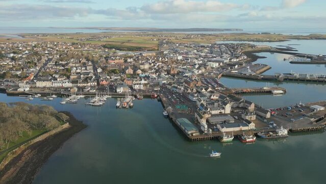 Aerial video of the Stornoway city houses on the sea shore, Main town on Isle of Lewis, Scotland