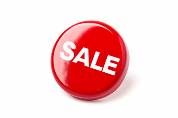 a vibrant red button with the word sale isolated on a bright white background signifying a promotional event
