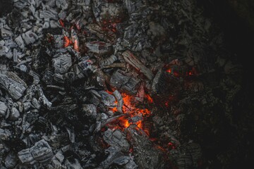 Closeup of burning charcoal and flames in dark setting