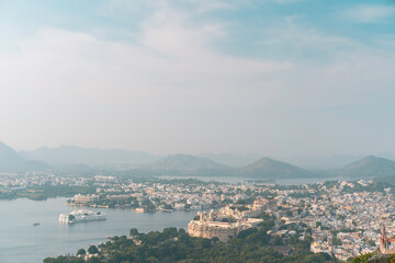 Elevated view of city with lake, landmarks at sunrise. Udaipur, India.