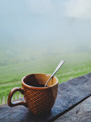 Coffee cup stand by for breakfast in front of Terraced rice field with fog in the air