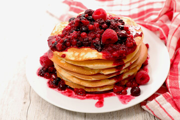 stack of pancake with berries fruits syrup