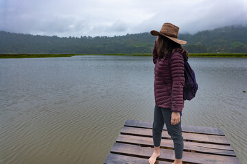 Traveler woman contemplates the landscape in the Peruvian jungle.