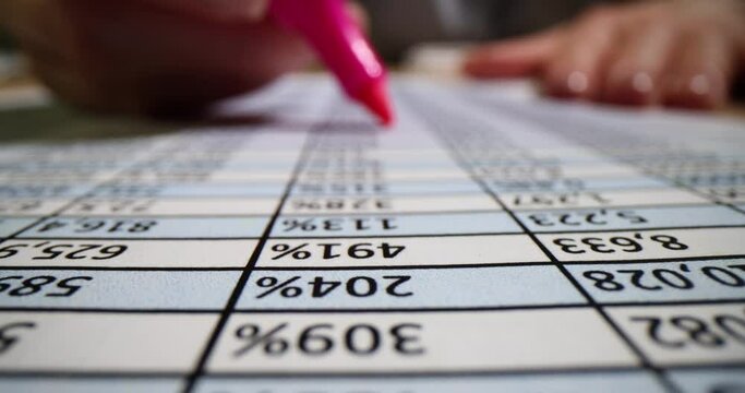 Secretary uses pink marker to highlight important data in table