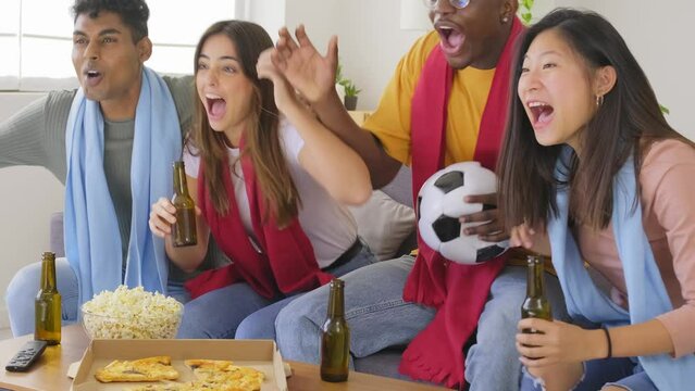 Happy friends football fans watching soccer on tv and celebrating victory at home - 4k video footage