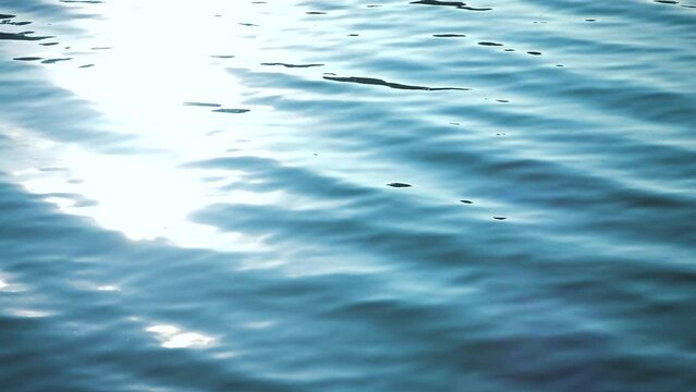 Beautiful reflection white sun light on blue water, rippled waves, calm natural crystal clean water, fresh, effect, scene, sea, wet, wavy, pool, shine, glow, slow motion, close up, hd. ProRes 422 HQ