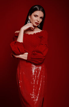 Studio fashion: adorable young woman dressed in red skirt and shirt. Portrait of charming beautiful girl
