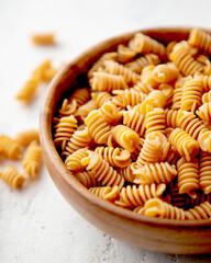 Organic Italian Chickpea Fusilli Pasta in a Wooden Bowl. Gluten-Free, Grain-Free, and Vegan Pasta. Healthy Eating Concept. View from Above.