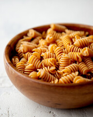 Organic Italian Chickpea Fusilli Pasta in a Wooden Bowl. Gluten-Free, Grain-Free, and Vegan Pasta. Healthy Eating Concept. View from Above.