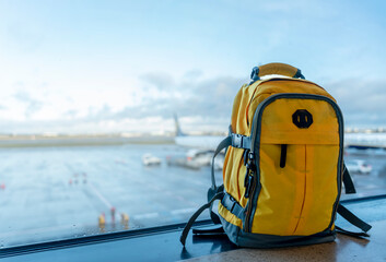 Yellow rucksack in airport. Travel concept. Travel touristic concept. travel light