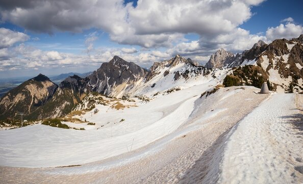 Scenic landscape featuring snow-capped mountain peaks and rolling clouds in the sky, Austria