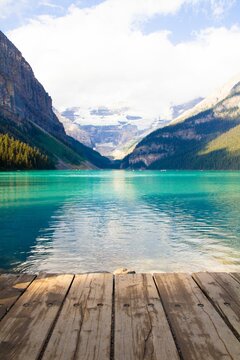 Wooden dock situated on the edge of a picturesque mountain lake, in Banff, Canada © Wirestock