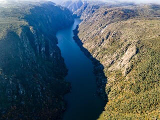 Fototapeta premium view of the Douro river between the mountains and hills at sunset, Portugal
