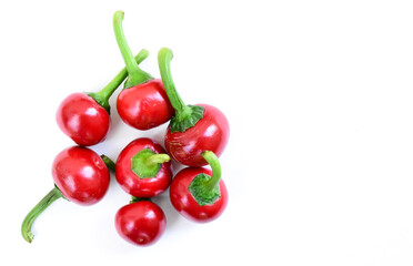 Bunch of cherry hot peppers isolated on white background. Red cherry chili peppers side view and top view