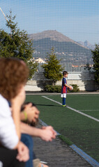 Boy playing a soccer game. Boy taking out the ball