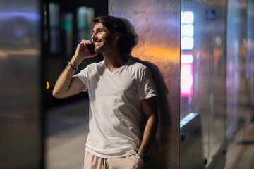 View of young man using a smartphone at night