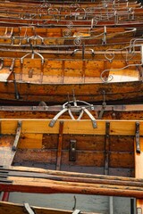 Vertical shot of wooden rowing boats side-by-side