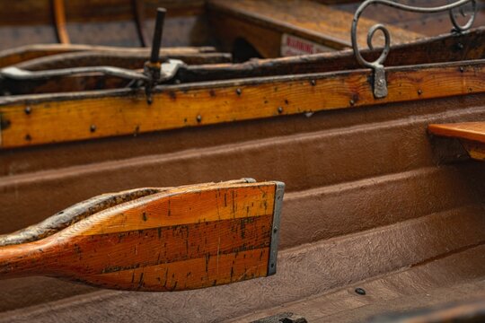 Closeup of a paddle attached to the wooden rowing boat