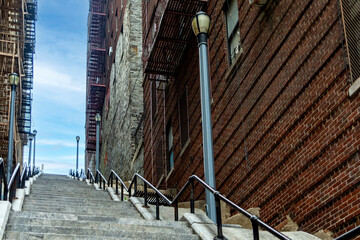 The famous Joker stairs with a beautiful blue and sunny sky in the famous neighborhood of The Bronx, the famous borough of New York in USA.