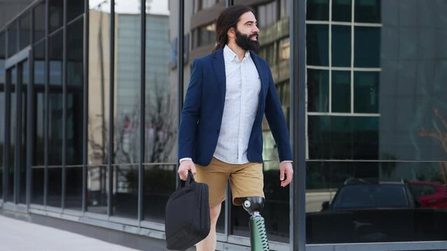 Businessman with a leg prosthesis strides forward, reflecting determination and professionalism.