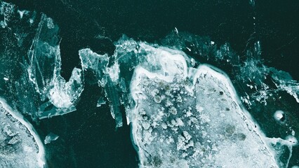 Several ice pieces in a dark and mysterious aquatic environment - obrazy, fototapety, plakaty