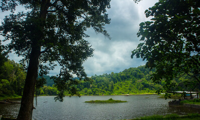 Situ gunung lake in indonesia. Forest lake under cloudy sky