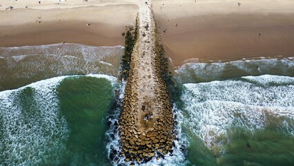 Aerial view of sea waves washing beach