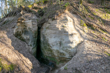 landscape with sandstone rock outcrop and cave, devil's cave near Vaidavmuiza, Valmiera county, Latvia