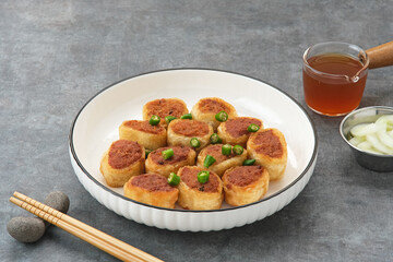 Gohyong or Ngo Hiang, made from minced chicken with flour, served with sour sauce
