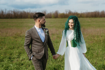 a bearded groom and a girl with green hair dance and twirl