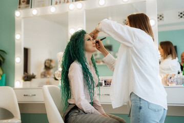 portrait of a bride with green curly hair in the beauty room