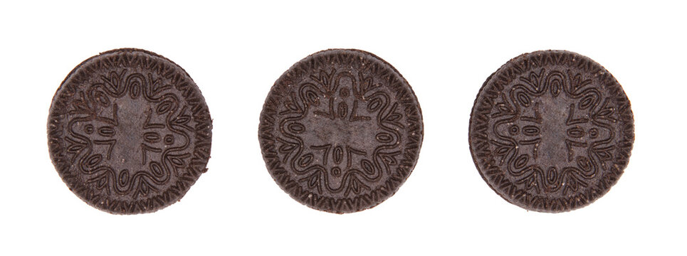 Top view of three black cookies with white cream in a row isolated on a cutout PNG transparent background