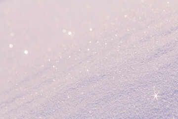 Pale pink snow surface sparkling in morning sunlight background