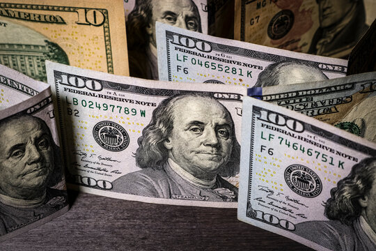 Unusual angle - American dollar bills on a dark table.