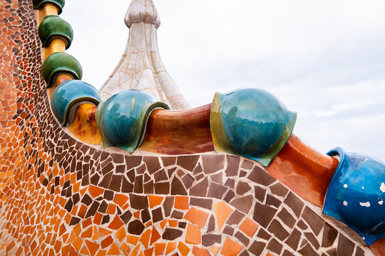 The roof and chimney of Casa Batllo in Barcelona, the building designed by Antoni Gaudi. The facade is decorated with ceramic mosaics.