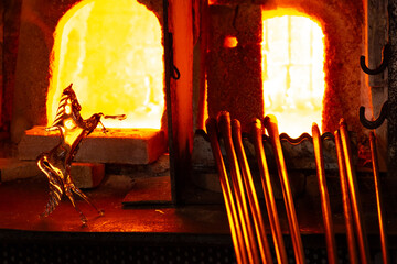 Glass master working in front of the furnace in Murano Island in Venice Italy