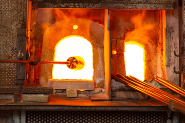 Glass master working in front of the furnace in Murano Island in Venice Italy