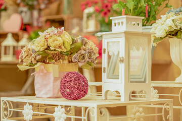 modern floral composition on elegant table with lantern and ornament
