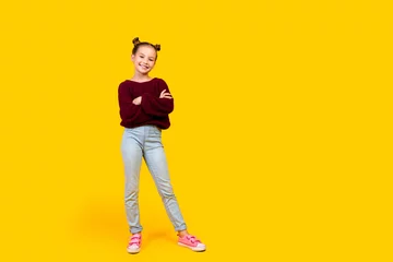  Full length photo of adorable positive schoolkid folded arms good mood empty space isolated on yellow color background © deagreez