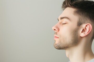 Obraz premium calm male with eyes closed, space on left for copy