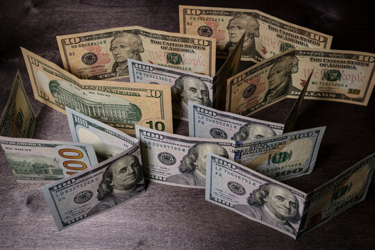Unusual angle - American dollar bills on a dark table.