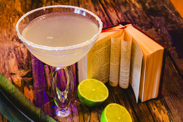 Margarita cocktail with lime in a glass on wooden table. Shallow dof