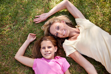 Mother, daughter and portrait on grass with smile for bonding, support or aerial view on holiday in...