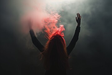 person with arms raised, smoke hair becoming red flames