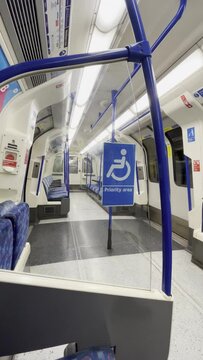 Priority area, disabled, senior person, impaired, pregnant sign with wheelchair on underground in London, UK, at Oval station, vertical video