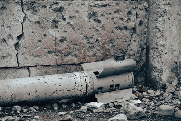weapon rocket lying on the ground near the wall in Ukraine